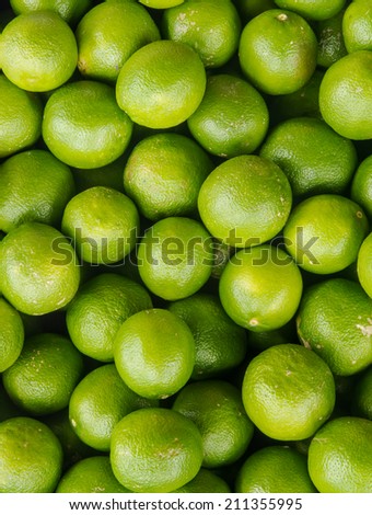 Fresh green lemons background