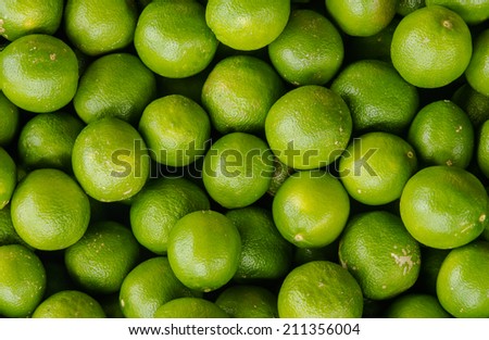 Fresh green lemons background