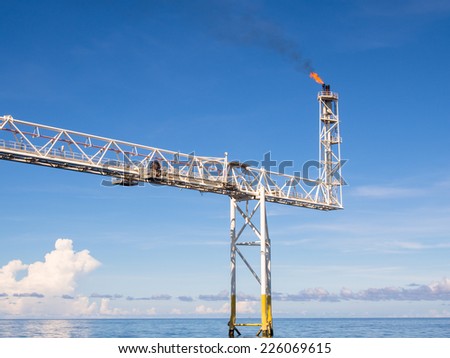 rigs tower with fire in the gulf.