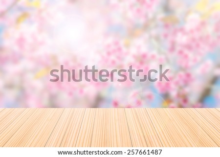 Empty wood table and pink flowers background. product display template.