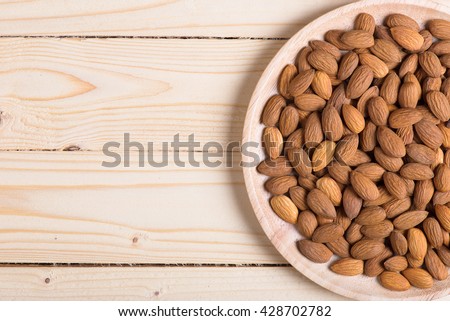 Almonds. Almonds on wooden table. Almonds background. Group of almonds. Peeled almonds. Pile of almonds. Almonds kernel. Almonds nuts.