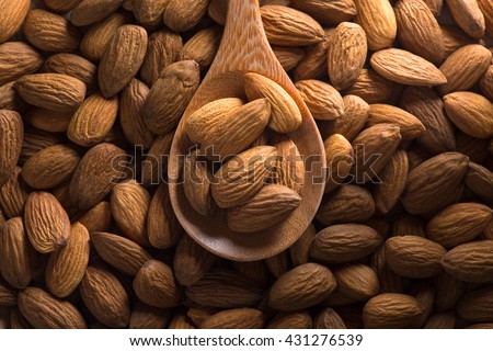 Almonds. Almonds on dark tone. Almonds background. Group of almonds. Peeled almonds. Pile of almonds. Almonds kernel. Almonds nuts.