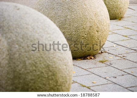 A shot of some stone spheres  in the street