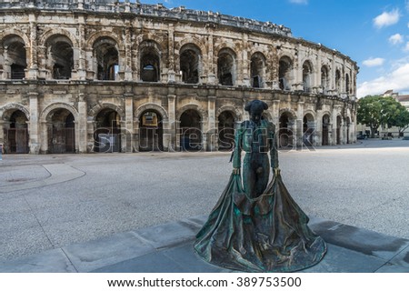 Roman Arena (Amphitheater) in Arles and bullfighter sculpture, Provence, France