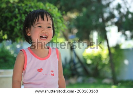 A laughing Asian baby with happy face