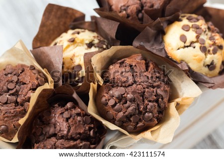 Chocolate muffins in wooden box, homemade bakery, close up, selective focus