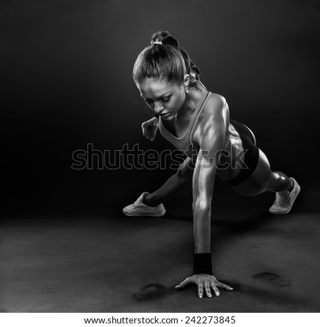 Young Woman Doing Push-Ups workout fitness posture body building exercise exercising on studio