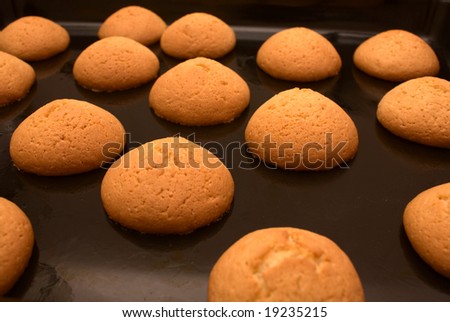 Fresh cookies just from an oven on a black sheet