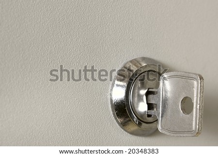lock with a key from a metal white box