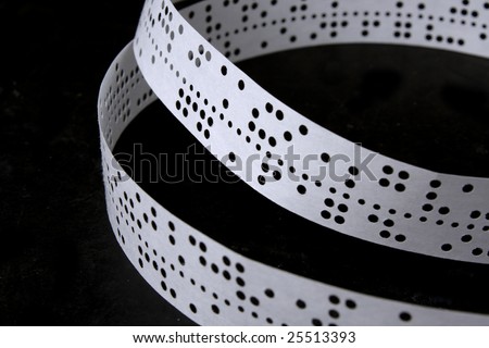 The punched tape on a black background lays rings