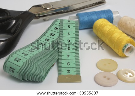 collection of sewing tools and supplies in a sewing kit, isolated on a white background