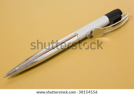 Metal business pen on the gold background