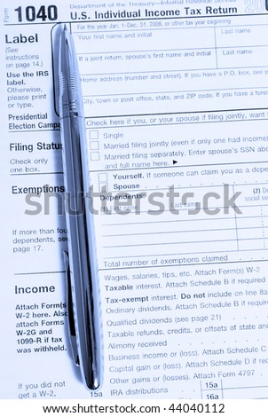 metal fountain pen on 1040 tax form in blue light