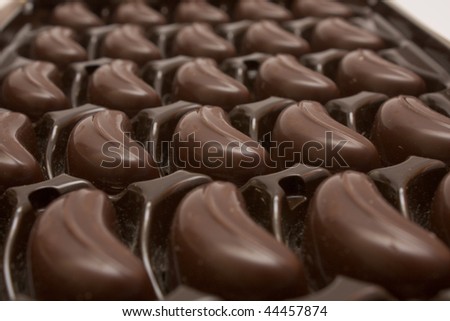 Box of chocolates inside. Dark chocolate in brown package.