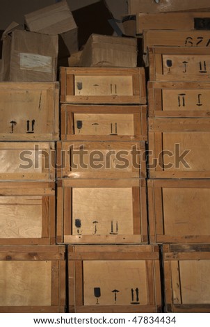 Old dirty plywood boxes in a warehouse. Contept of obstacle in business, the stale goods.