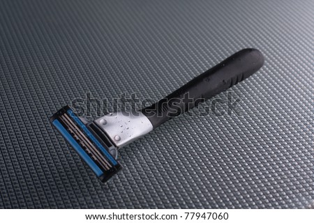 disposable shaving razor on a glass background