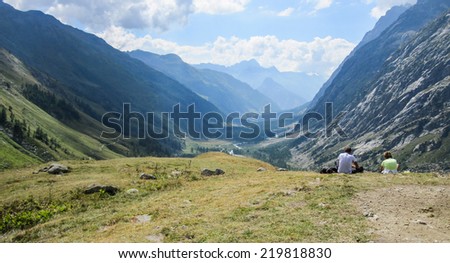Relax on the Alps. Landscape of tha Alps with two people in relax and viewing the panorama.