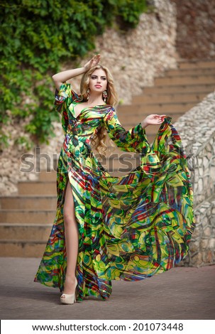 Fashion sexy woman, young glamour girl portrait. Luxury woman in long silk dress. Summer. young beauty woman in fluttering green dress. series