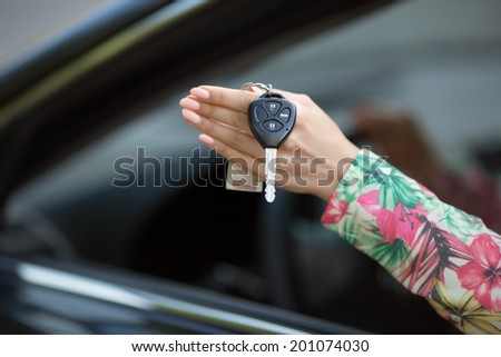 Woman with car keys, female driver holding car keys driving her new car.