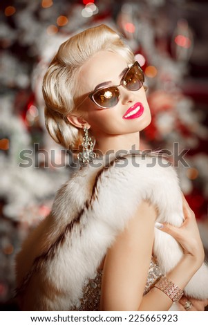 Beauty woman in luxury fur and fashion sunglasses, vogue style model at Christmas party new year background. Luxury lifestyle portrait girl. series