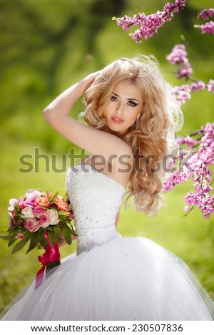 Beautiful Bride wedding day outdoors, happy bride woman with wedding flowers bouquet. Gorgeous bride vogue style model. Newlywed girl in green park. series