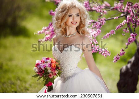 Beautiful Bride wedding day outdoors, happy bride woman with wedding flowers bouquet. Gorgeous bride vogue style model. Newlywed girl in green park. series