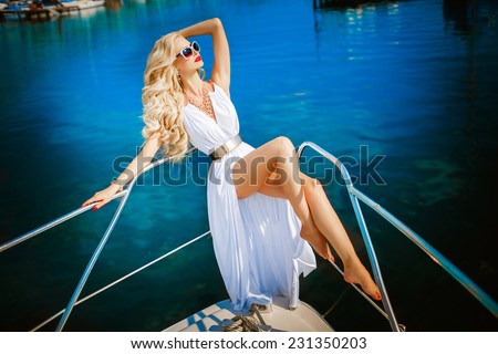 Fashion photo sexy woman blonde relaxing on yacht, vogue style model, luxury lifestyle woman, fashionable girl at vacation, alluring tanned girl, Monaco, series, soft sunset focus