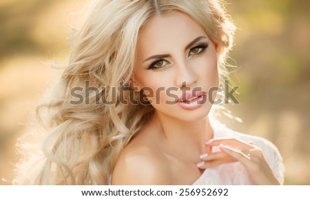 Beautiful woman outdoors spring girl portrait. Smiling young woman outdoors walking. natural beauty female face. Portrait of beautiful blonde lady at sunset series. soft light.