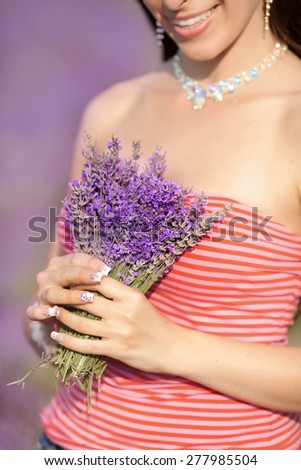 Beautiful woman lavender flowers, happy girl in lavender field, beauty female outdoor portrait, aromatherapy and health care, series, soft focus at sunset