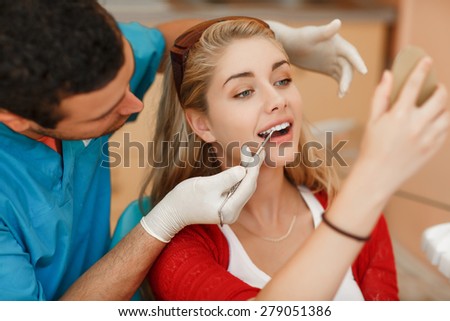 Dentist curing female patient Woman teeth examined at dentists teeth whitening. stomatology office Teeth care and tooth health. selective focus, series