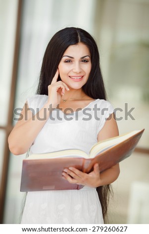 Female student outdoors campus college student young woman reading book girl with book, happy woman smiling, series.