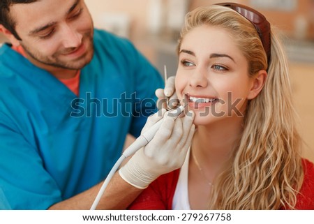 Dentist curing female patient Woman teeth examined at dentists teeth whitening. stomatology office Teeth care and tooth health. selective focus, series