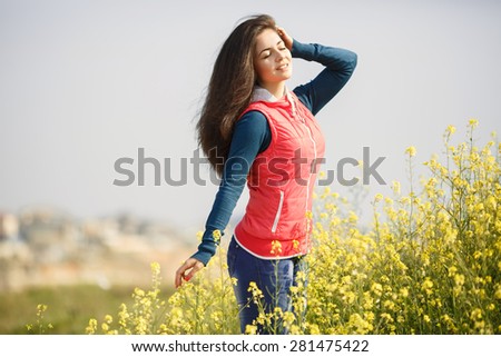 Beautiful smiling woman outdoors portrait happy girl in flowers field summer, Beauty young girl outdoors enjoying nature, series, soft focus sunset