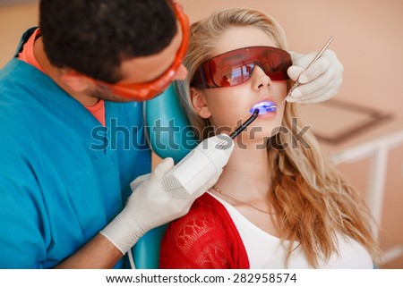 Dentist curing female patient dental care Woman teeth examined at dentists clinic Teeth care and tooth health. selective focus, series