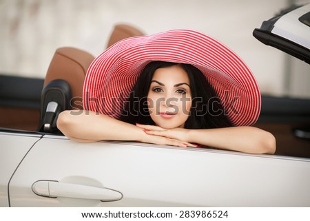 Beautiful woman car summer portrait girl in hat and red dress, glamour female in luxury car vacation lady, young woman in cabrio, series in my portfolio.