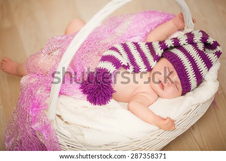 Cute newborn baby 1 month child sleeping in basket, adorable little girl new born kid portrait, happy baby portrait, beautiful little girl , soft tonality, series