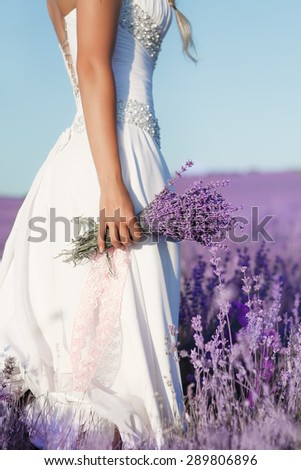 Woman with lavender flowers in lavender field, aromatherapy herb, girl in white dress hold lavender bouquet, series