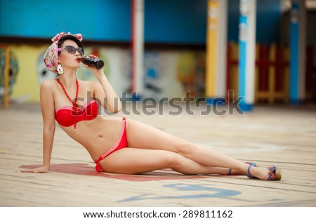 Beautiful young woman bikini pinup at beach, happy girl retro style in swimsuit, sensual brunette female in elegant swimwear resting near sea at Miami, soft focus, series