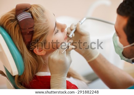 Female patient at Dentist, teeth care at dental clinic young girl with perfect smile at dentistry,  woman treat caries in tooth, Woman has teeth examined at dentists, tooth health. selective focus
