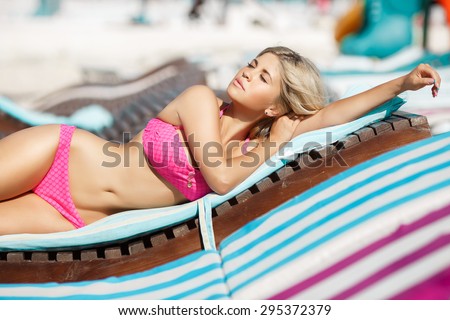 Beach woman sexy girl bikini model at pool, glamour blonde female in swimsuit relaxing at beach, vogue style model in swimwear, happy lady summer vacation portrait, girl in pink bikini outdoors