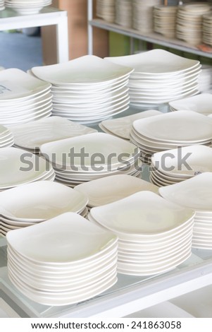 A lot of white plates in a shop