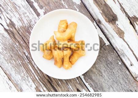 Deep-fried dough stick on wood