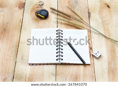 Note book and pencil on wooden background - vintage effect style pictures