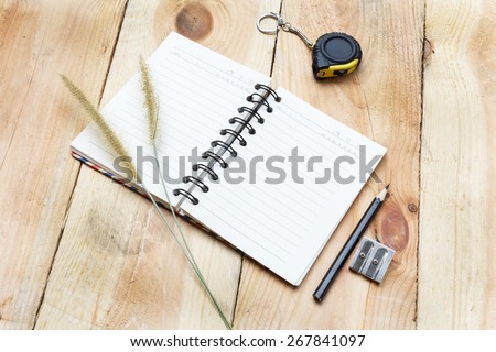 Note book and pencil on wooden background - vintage effect style pictures