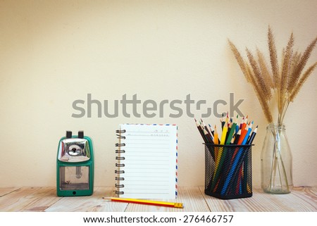 Color pencils and book on wooden background - Vintage effect style pictures