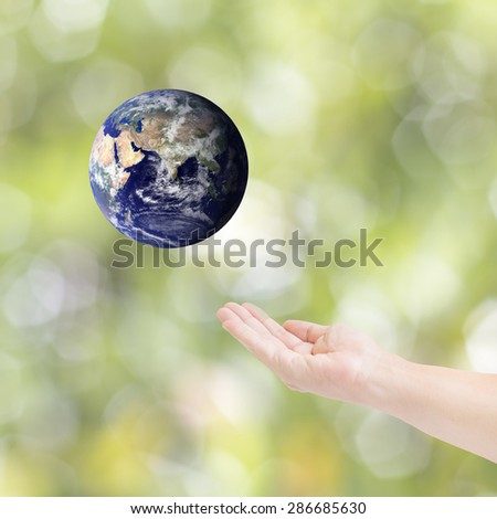 Human hands carrying global Earth. Environment concept. Elements of this image furnished by NASA.