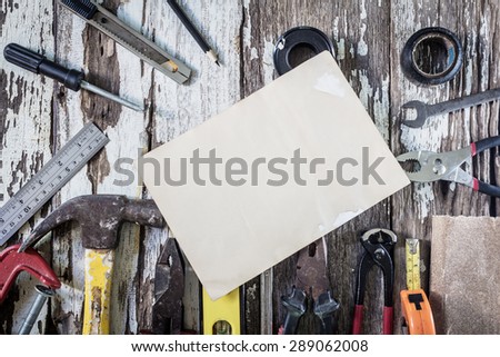 Organized copyspace white blank sheet of paper and tools on wooden board