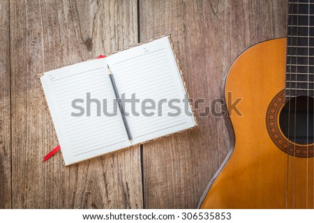 Notebook with guitar for writing music , Concept of music