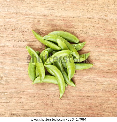 Sugar snap pea on wooden table