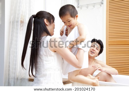 Mother wiping the body of her son with a towel